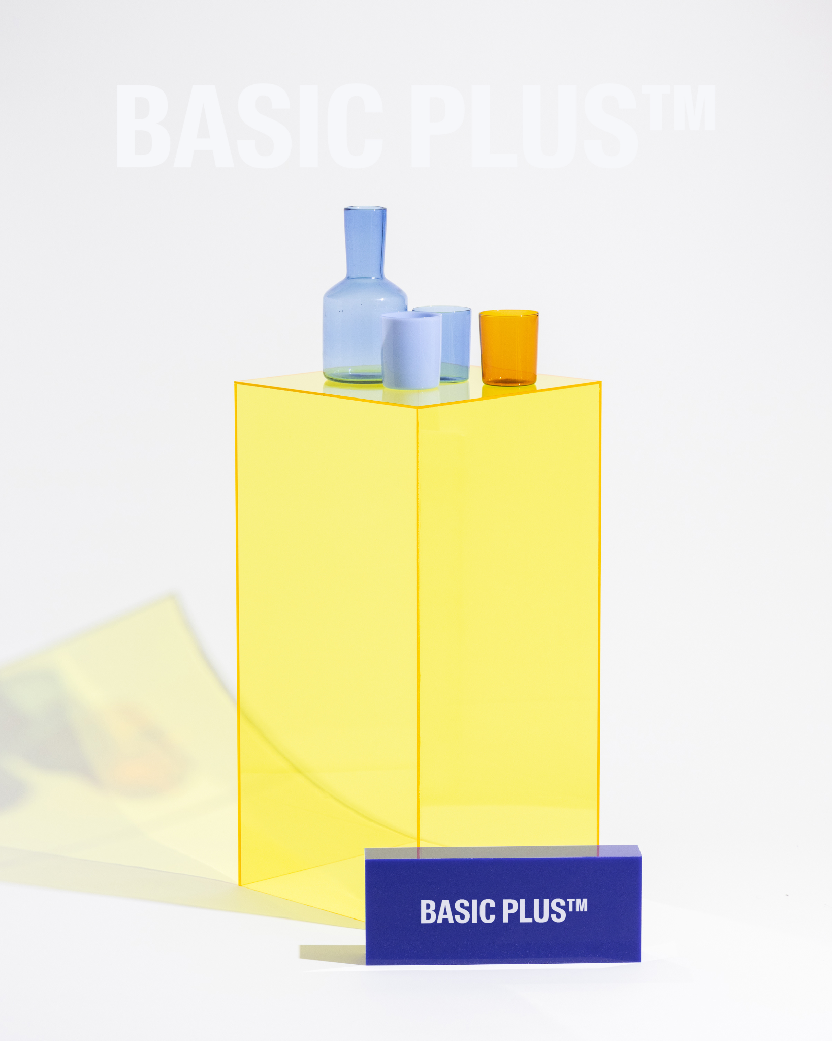 Transparent yellow acrylic display plinth front three-quarter view